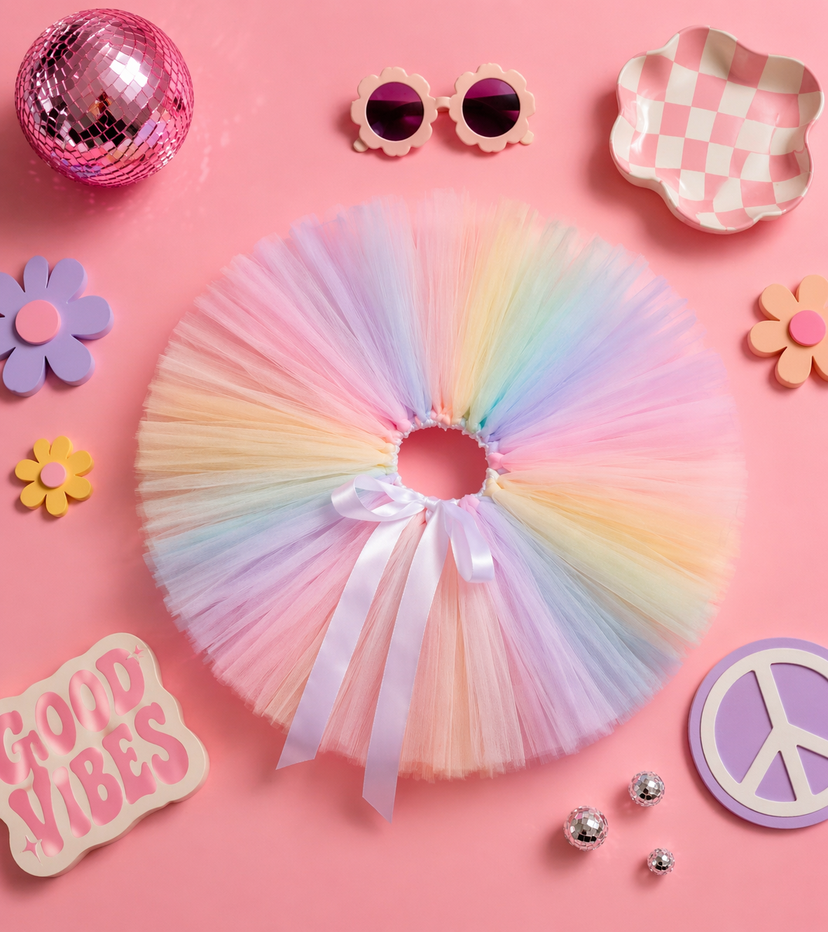 Pastel-colored tutu with accessories on a pink background